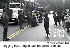 Logging truck near protesters